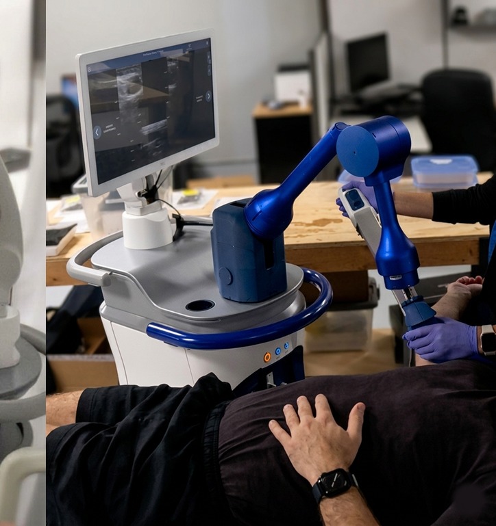 Usability testing photo showing the robotic arm and touchscreen positioned during a femoral procedure